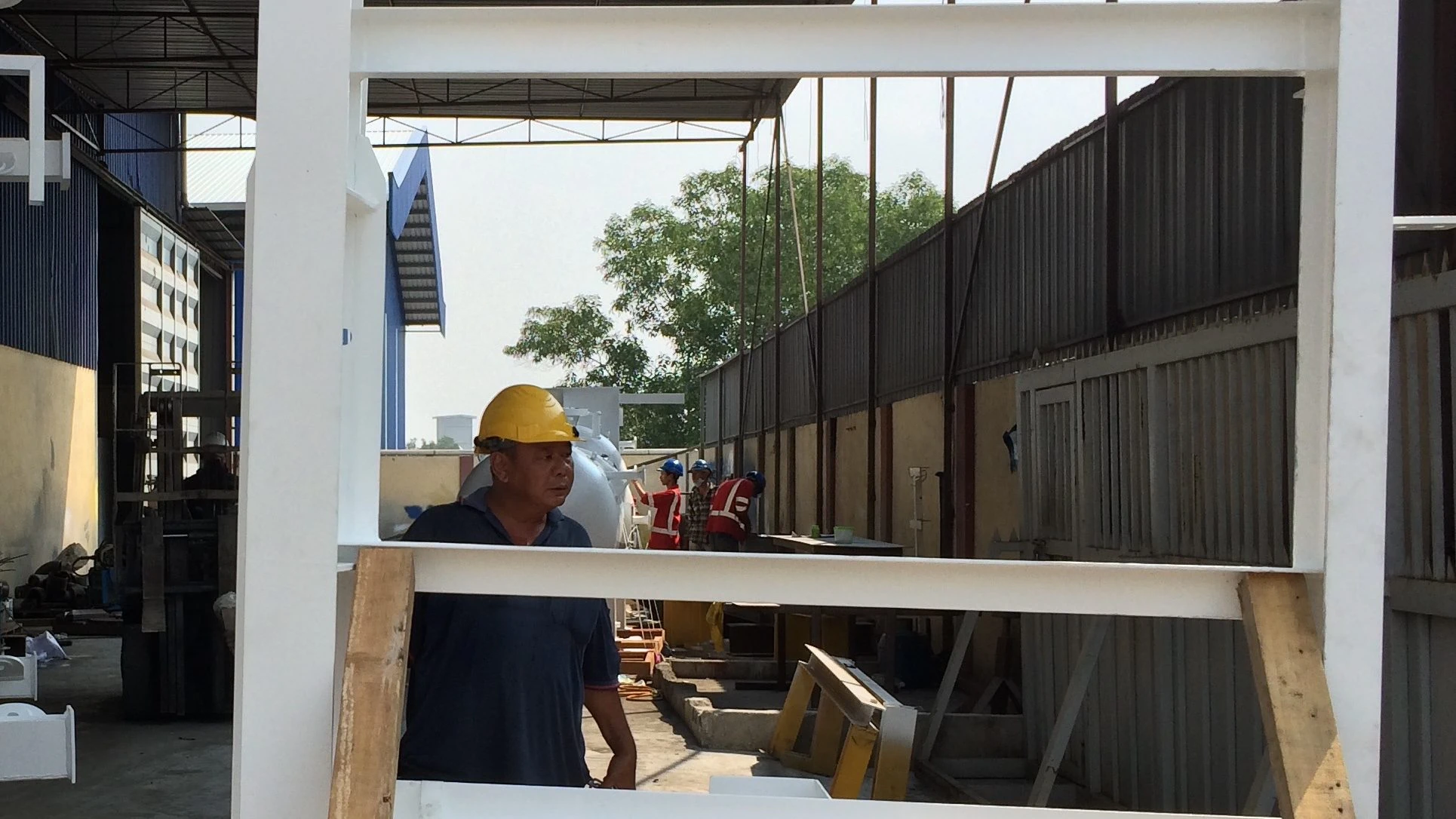 Fitters assembling an LPPU skid frame in the fabrication shop, 2014